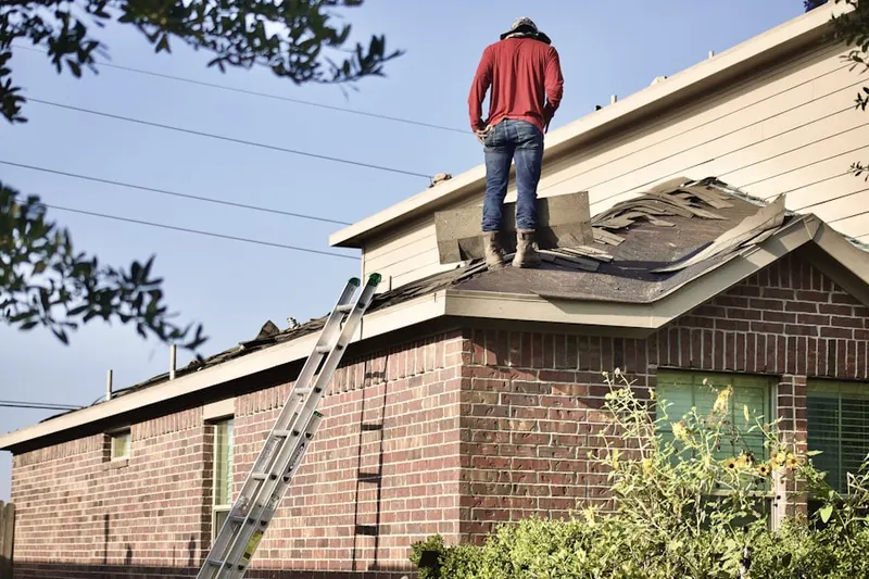 Professional roofer working on a residential roof in Childs Park